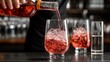 © AsterionMad - Bartender Pouring Rose Wine into Glass with Ice