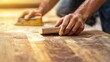 © Jorda - Carpenter sanding wood surface in workshop. Indoor workshop