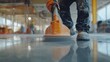 © LorelEino - A laborer polishing a concrete floor in a construction area. Featuring attention to detail