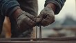 © Jorda - Construction worker tying rebar at a concrete site. Featuring attention to detail and safety