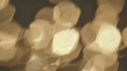 Poster - Shimmering golden bokeh lights twinkling in soft focus motion at night