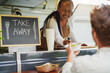 © DisobeyArt - African american senior woman serving takeaway food inside food truck - Small business and summer concept - Soft focus on female face