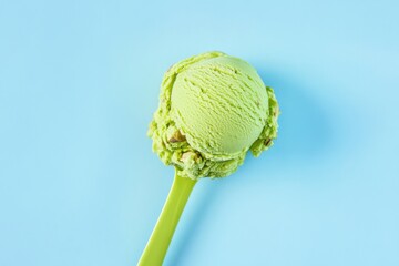 Poster - A green ice cream scoop against a plain blue background. Great for summer themed designs with a light, airy, and minimalist aesthetic.