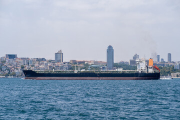 Poster - Bosphorus waterway bustling with maritime activity featuring a cargo ship navigating through the strait