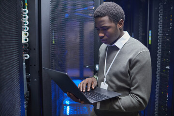 Poster - Technician working on configuring server racks inside modern data center, ensuring system functionality and network connectivity