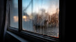 © PhotoArtHub - Close-up of a windowpane covered in condensation, blurring the sunset view.  Water droplets create a textured surface, symbolizing cold weather or a change of season.