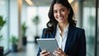 © Kavinuva Creations - Confident Young Businesswoman in Navy Suit Holding Tablet – Modern Office Portrait