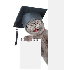 Aufkleber - Сollege graduate kitten holds blank list in it paw and looks from behind blank white banner. Empty space for text. Isolated on white background