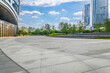 © zhao dongfang - Modern city business park with empty paved plaza ground and contemporary office building exteriors background.