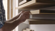 © MutshI - Carpenter installing wooden shelving in home office. Featuring shelving installation