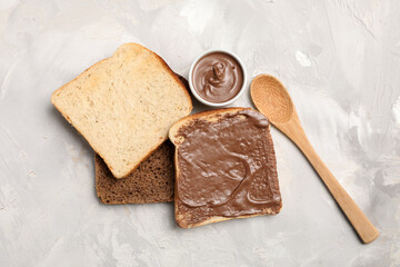 Wall Mural - toasts with sweet chocolate spread on grey background