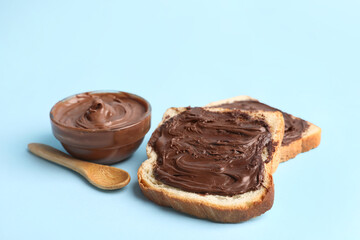 Wall Mural - toasts with sweet chocolate spread on blue background