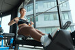 © 2B - Rowing workout session in a modern gym with large windows showcasing natural light