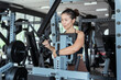 © 2B - Woman performing strength training in a modern gym during early morning hours for fitness routine and personal health goals