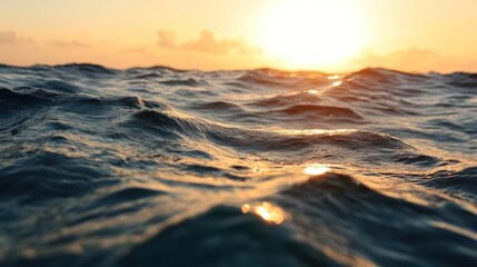 Aufkleber - A scenic close-up capturing the ocean's surface at sunset, where blue waters reflect the warm, golden sunlight. The image focuses on the rhythmic waves, creating a serene and picturesque seascape