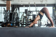 © 2B - Woman practicing yoga in a fitness studio during a morning workout session, focusing on forward bend position for flexibility