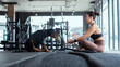 © 2B - Woman training her dog at the gym during morning workout session focused on obedience and fitness