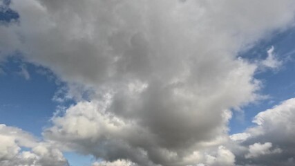 Wall Mural - Incredibly beautiful grey cumulus textured clouds under blue sky on partly cloudy day. Timelapse mode.