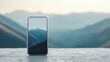 © OngCaLucK - Smartphone with mountain landscape on screen capturing scenic view with distant peaks and sky in a minimalistic outdoor setting.