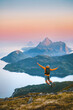 © EVERST - Man jumping enjoying mountains view travel solo in Norway active adventure vacations, tourist backpacker hiking healthy lifestyle freedom awakening concept dreamy sunset islands and sea landscape