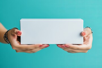 Poster - Hands presenting a white rectangular box against a bright turquoise colored background image art
