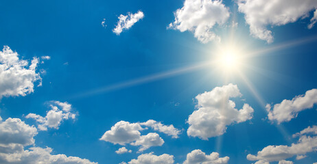 Wall Mural - bright sun on beautiful blue sky with white clouds.