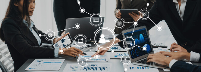 Aufkleber - a group of professionals engages in a business meeting, utilizing digital devices to analyze data an