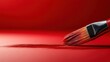 © gilemixmedia - This image of a painting brush smoothly spreading red paint captures the essence of artistic expression and the fluidity of creativity in a captivating artistic environment.
