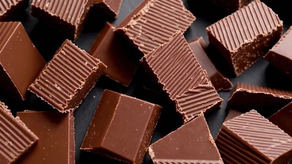 Aufkleber - Sweet milk chocolate chunks on a dark background create a tempting visual, perfect for projects related to confectionery, desserts, or indulgence