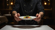 © Ekaterina Kotova - waiter holding a plate with food