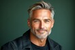 © R - Chic men's undercut haircut - midlife white man with blond hair. Green solid background. A cheerful and poised gentleman standing elegantly. Creative of style for aging men.