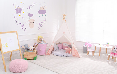 Poster - Cozy playroom with toys, furniture and cute wallpaper. Stylish children's room interior