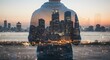 © Image - Person overlooking city skyline at twilight, creating a double exposure effect with the urban landscape and their own form.