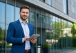 © Anim - smiling male entrepreneur working with technology in city business district