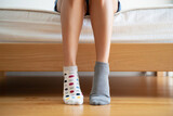 The feet are wearing different socks