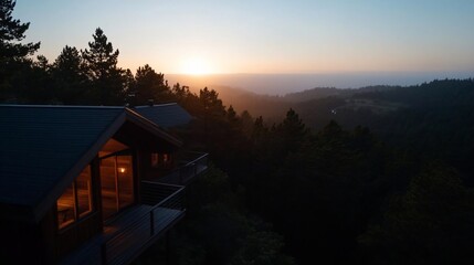 Poster - Scenic view of a house amidst a forest bathed in the golden light of a sunset. The silhouette of trees and rolling hills create a tranquil atmosphere