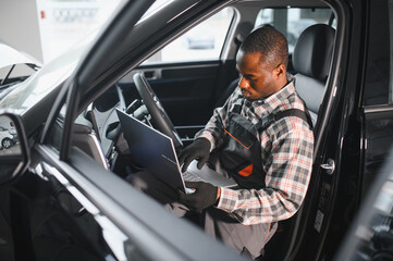 Poster - Automobile computer diagnosis. Car mechanic repairer looks for engine failure