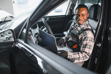 Poster - Automobile computer diagnosis. Car mechanic repairer looks for engine failure