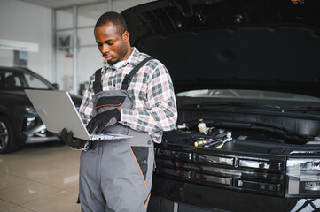 Poster - Automobile computer diagnosis. Car mechanic repairer looks for engine failure