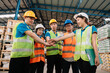 © Nuttapong punna - Happiness engineer and worker team group joining hands at cargo containers. .
