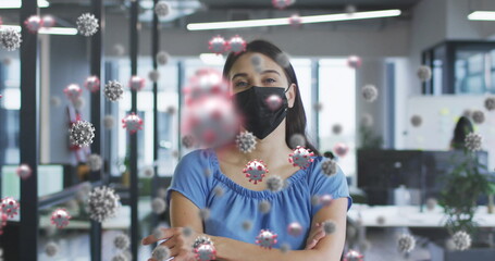Poster - Image of virus cells over caucasian woman wearing face mask