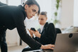 © qunica.com - Two businesswomen work collaboratively in an office, emphasizing teamwork, technology, and productivity. The image highlights professionalism, modern corporate culture, and an engaging work