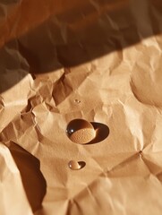 Poster - Minimalist Still Life of Glass Spheres on Textured Brown Paper with Warm Sunlight and Shadows