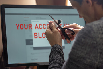 Poster - Angry upset man cutting with scissors blocked credit card. Man checking computer, worried about payment card lock and blocked account