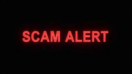 Aufkleber - Bright red 'SCAM ALERT' sign displayed in a dark setting, warning viewers about potential fraud.