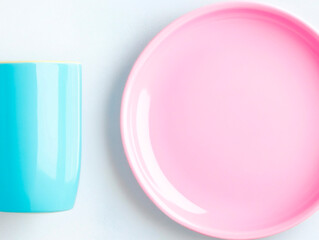 Poster - bright pastel blue cup and pink ceramic plate on light background, minimal flat lay composition with