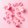 © DriftPixels - Delicate pink roses and scattered petals on a soft pink background creating a romantic and serene mood captured in a flat lay style