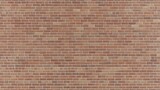 A seamless texture of a vibrant red brick wall with thin white grout lines
