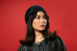 © Bliss - Young woman embodies modern fashion with stylish confidence against vibrant backdrop