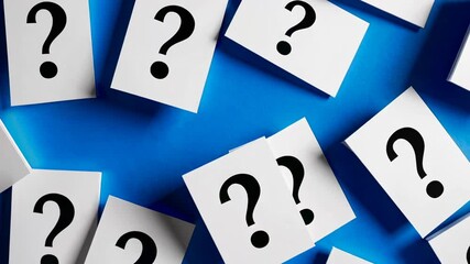 Aufkleber - Multiple white papers with black question marks lie scattered across a vibrant blue surface, creating a visual representation of uncertainty, inquiry, and the search for answers